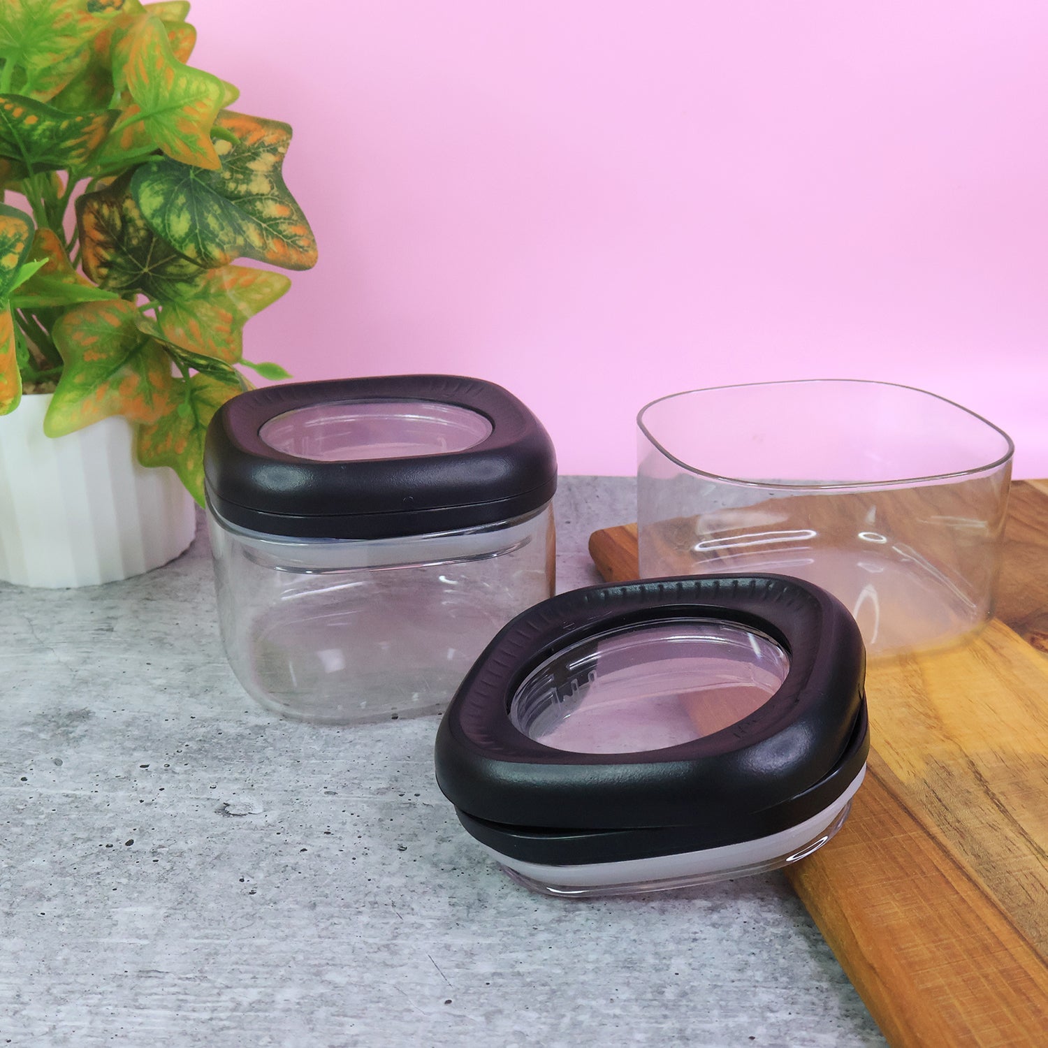 Two transparent plastic storage containers with twist and lock lids by Supermom