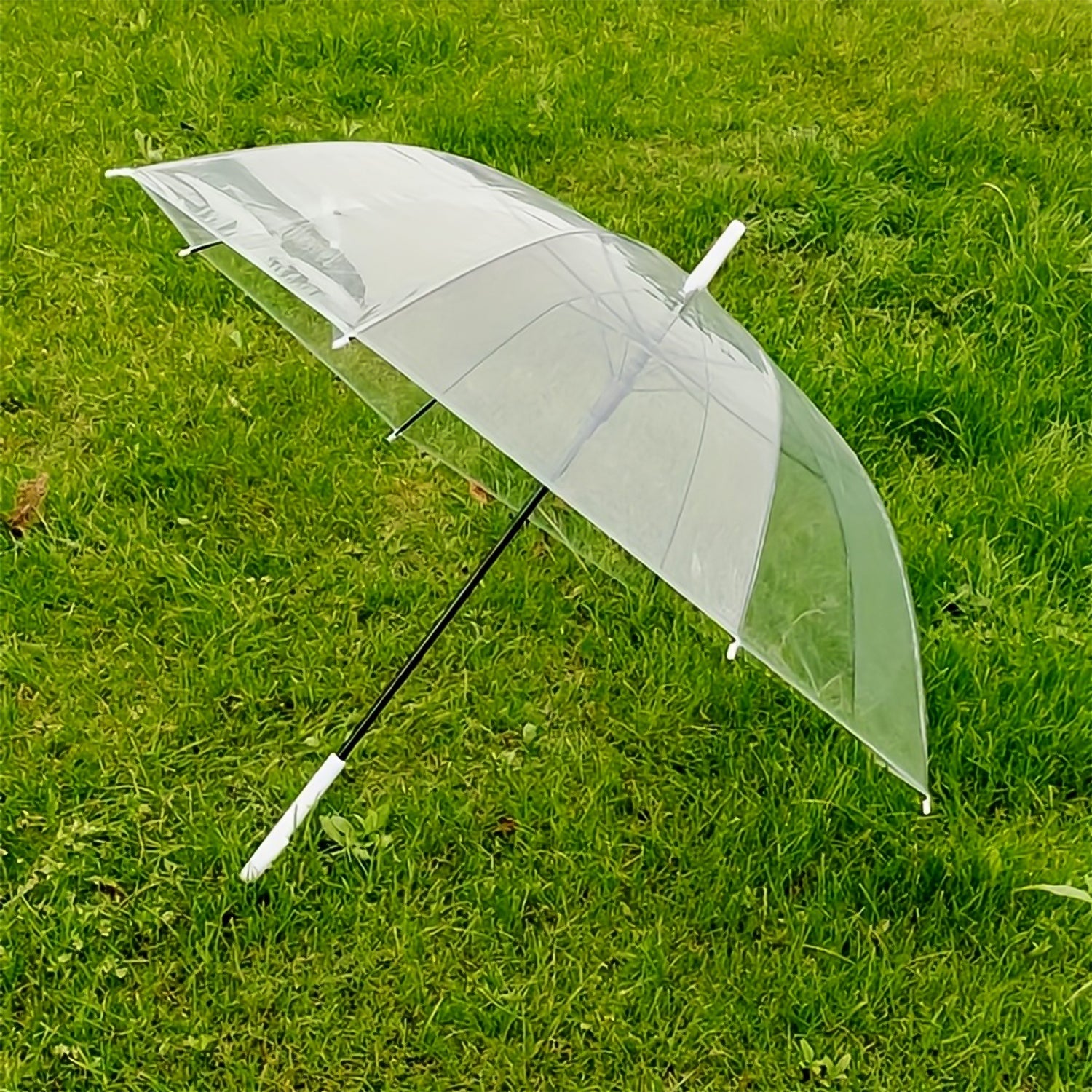 Close-up of curved handle on transparent dome umbrella for comfortable grip