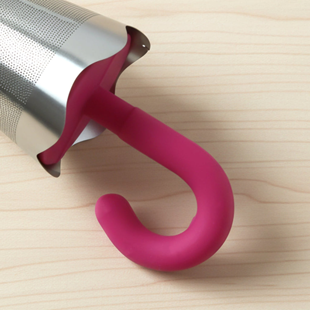 Reusable stainless steel umbrella-shaped tea infuser, an eco-friendly alternative to tea bags.