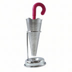 Stainless steel umbrella tea infuser resting securely on its dedicated drip tray stand, preventing spills.