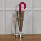 Stainless steel umbrella tea strainer with drip tray stand displayed on a clean white background.