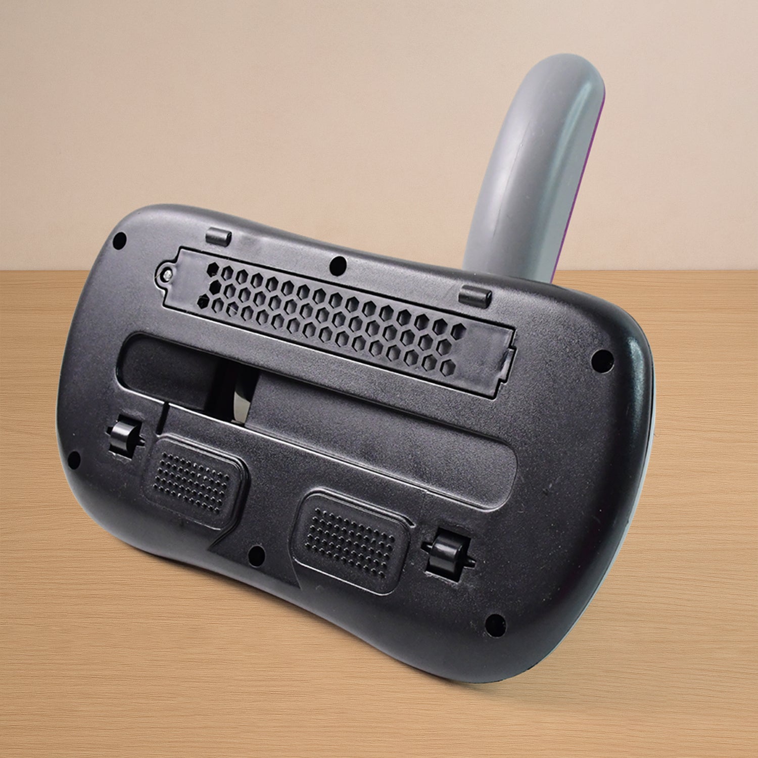 Low noise vacuum cleaner operating on a grey sofa fabric.