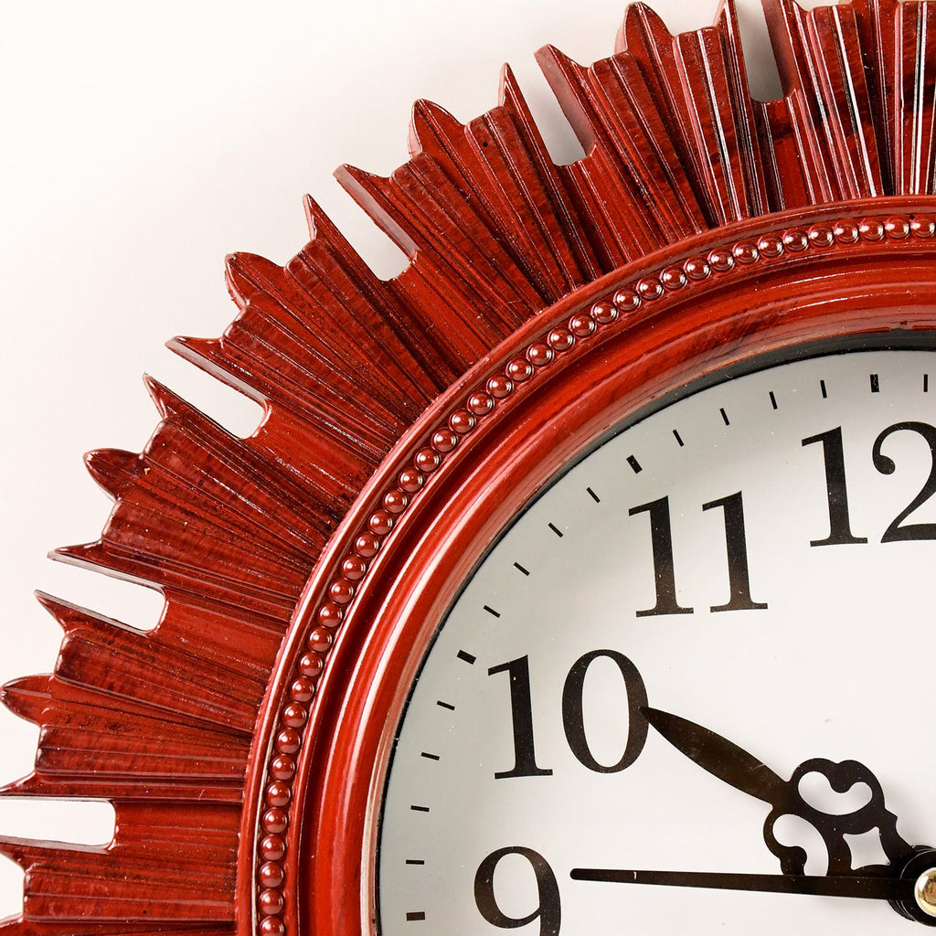Side profile of the round wooden look wall clock, showcasing its slim design and plastic finish.