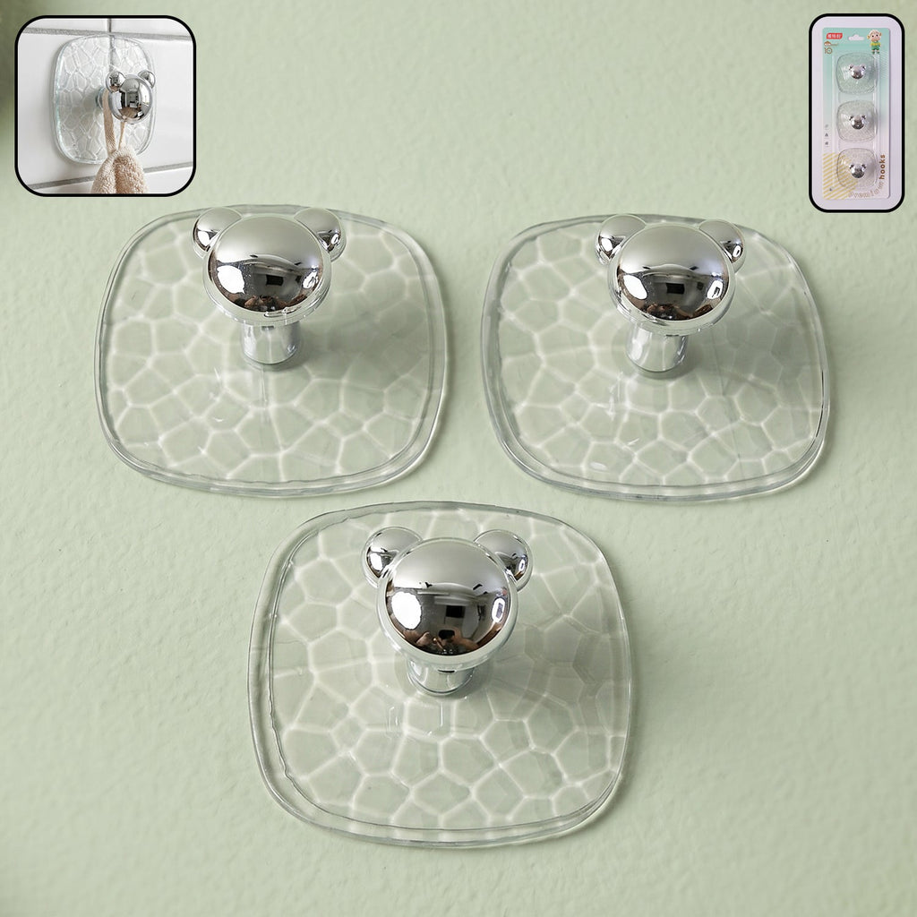 Strong clear adhesive wall hook holding keys and bags on a white wall.