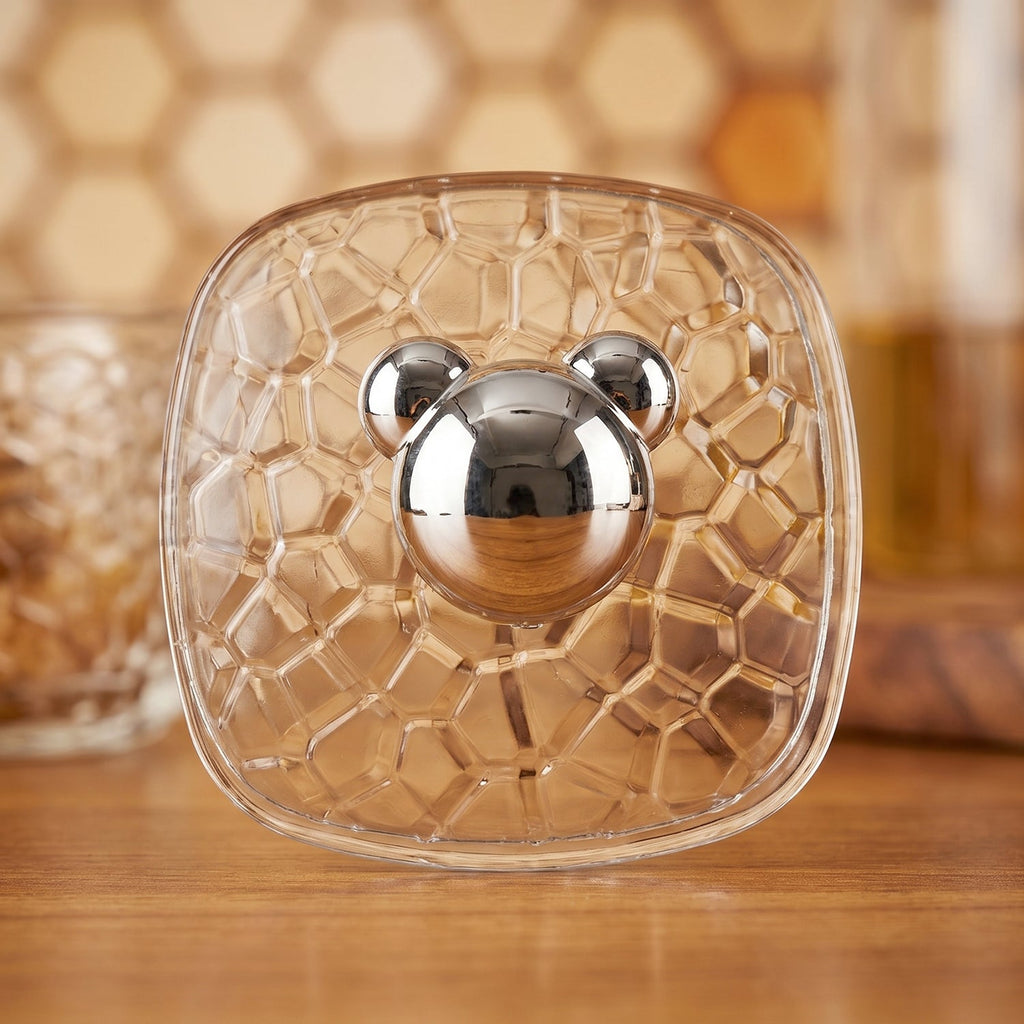 Set of three clear plastic adhesive wall hooks displayed on a flat surface.