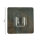 Adhesive wall hanger hook on smooth surface shown in use