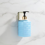 Side view of minimalist wall-mounted liquid soap dispenser in white finish
