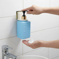 Wall-mounted liquid soap dispenser installed in modern bathroom