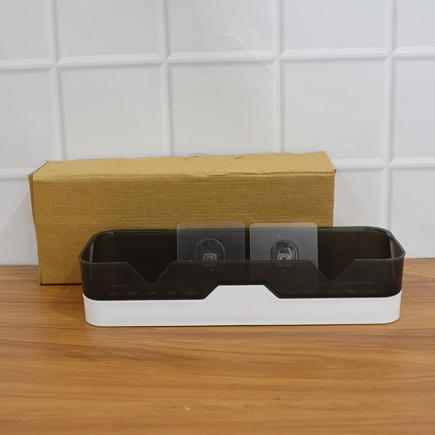 Adhesive shelf mounted on wall displaying bottles and toiletries