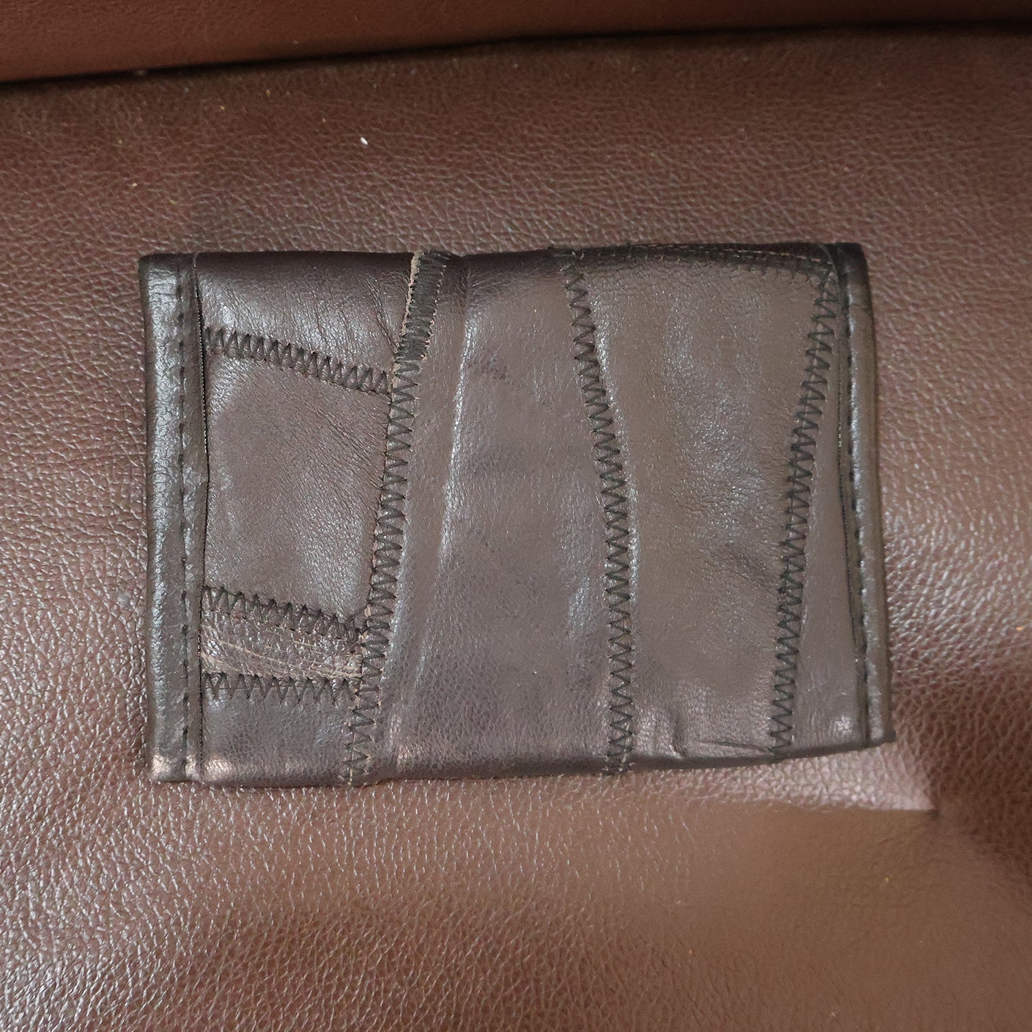 Texture detail of genuine leather on slim bi-fold wallet surface