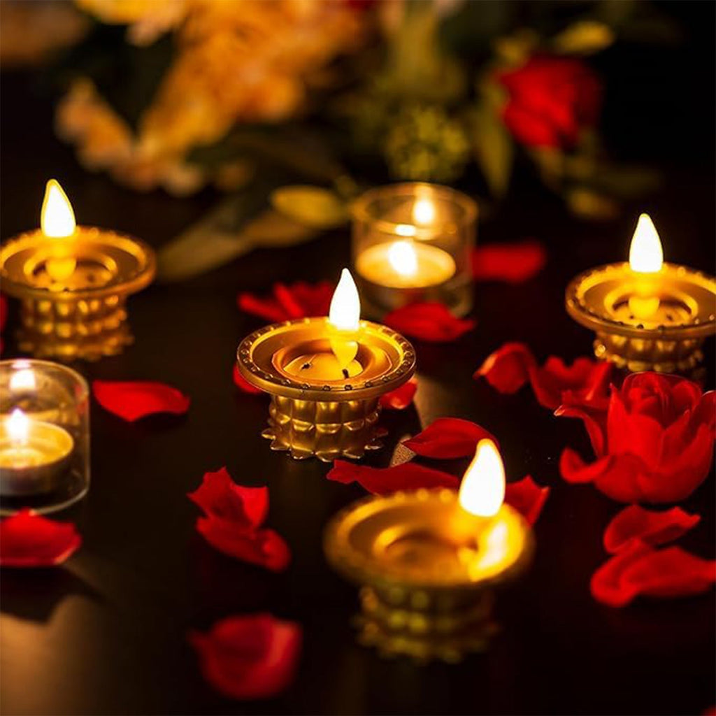 Multiple golden water sensor diyas illuminating a traditional Indian setting.