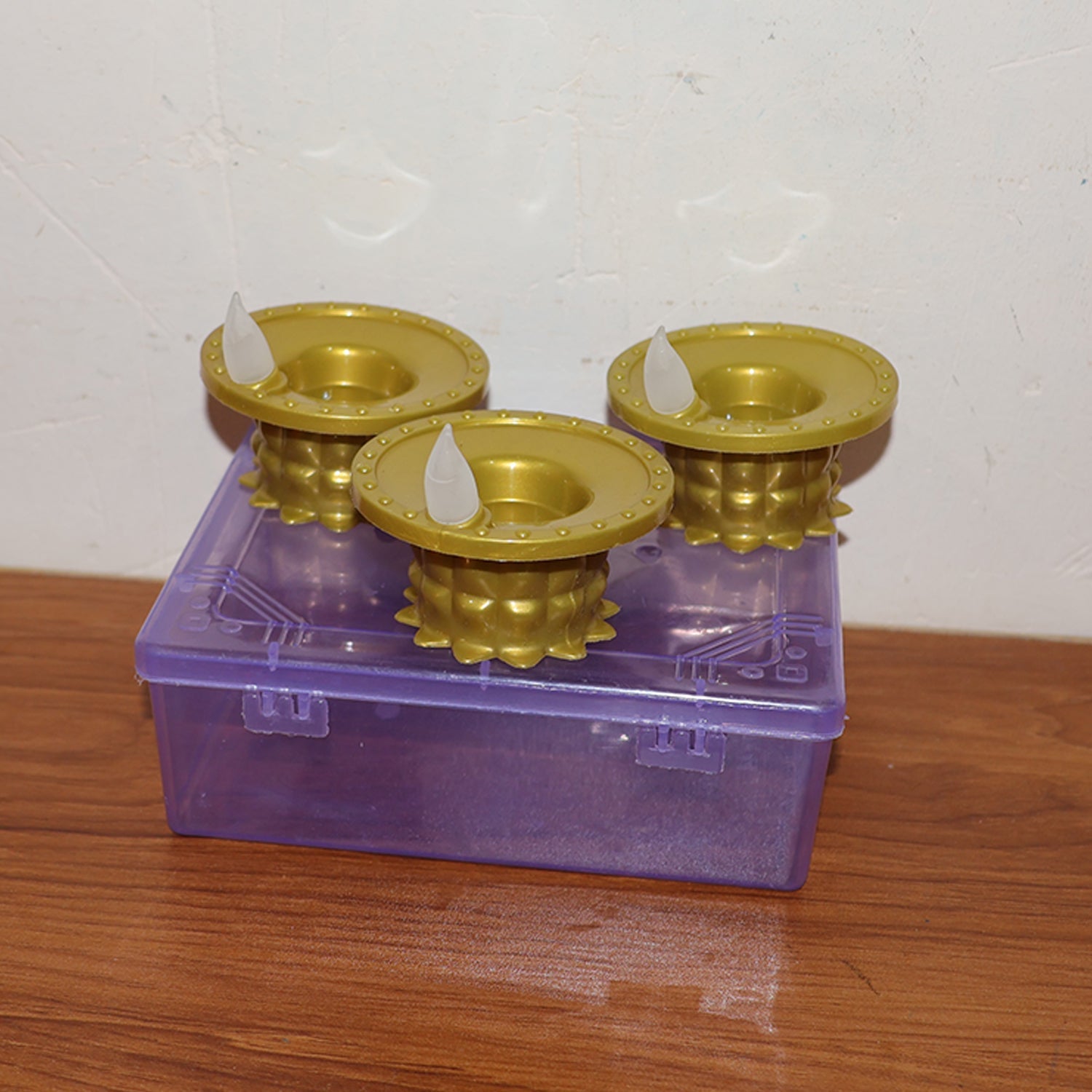 Water sensor LED diya showcased with its battery compartment.
