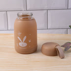 Glass bottle displaying brown bunny print with secure lid