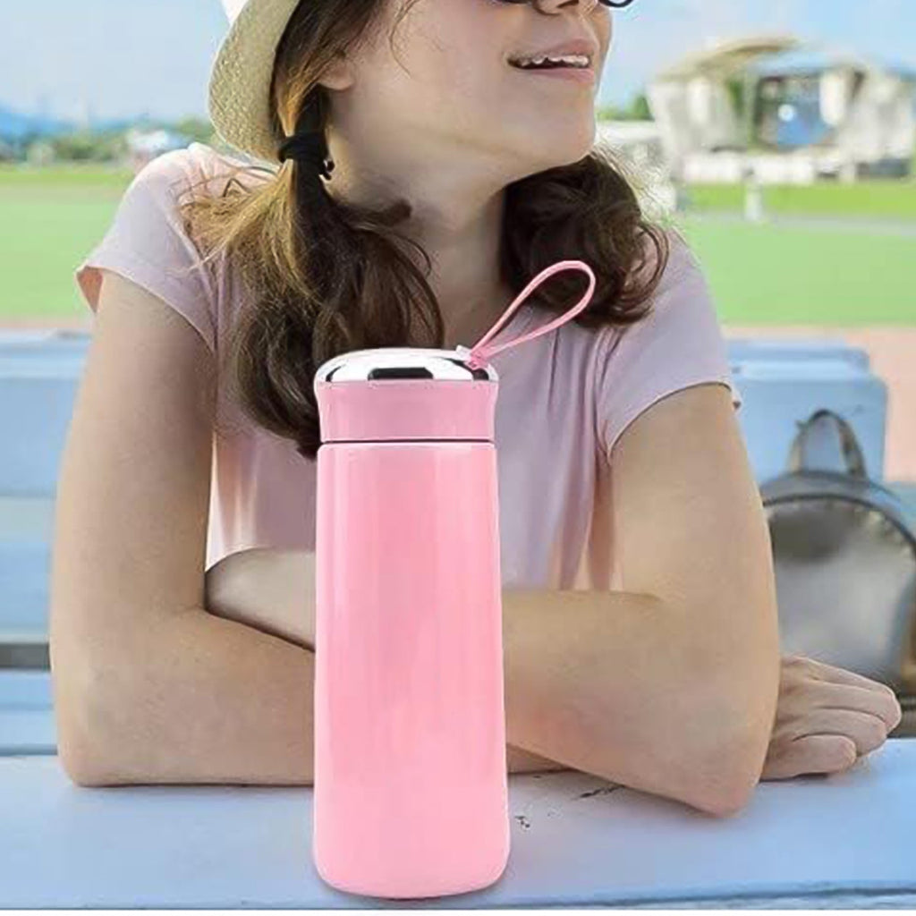 Hydrozilla pink glass water bottle in lifestyle gym setting