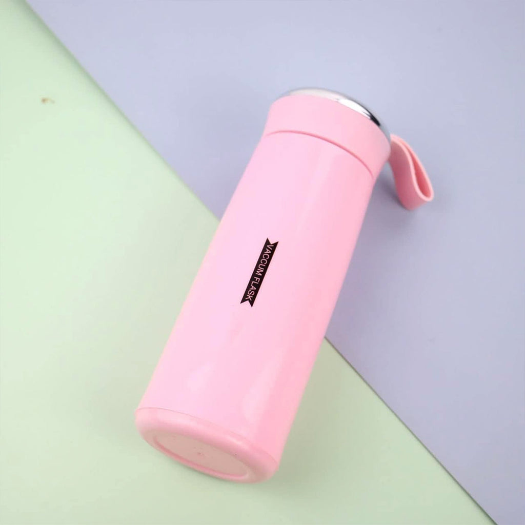 Close-up of pink glass water bottle with secure bamboo lid