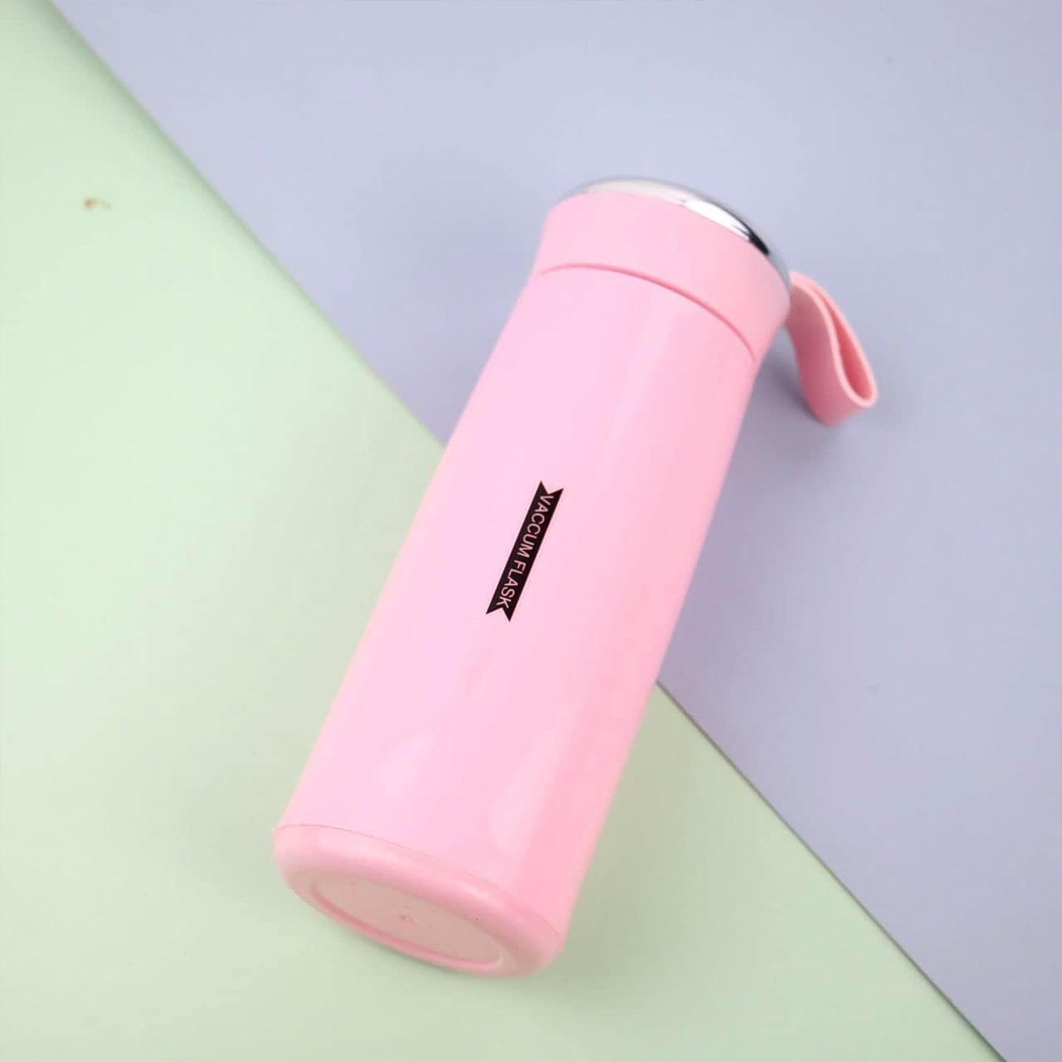 Close-up of pink glass water bottle with secure bamboo lid