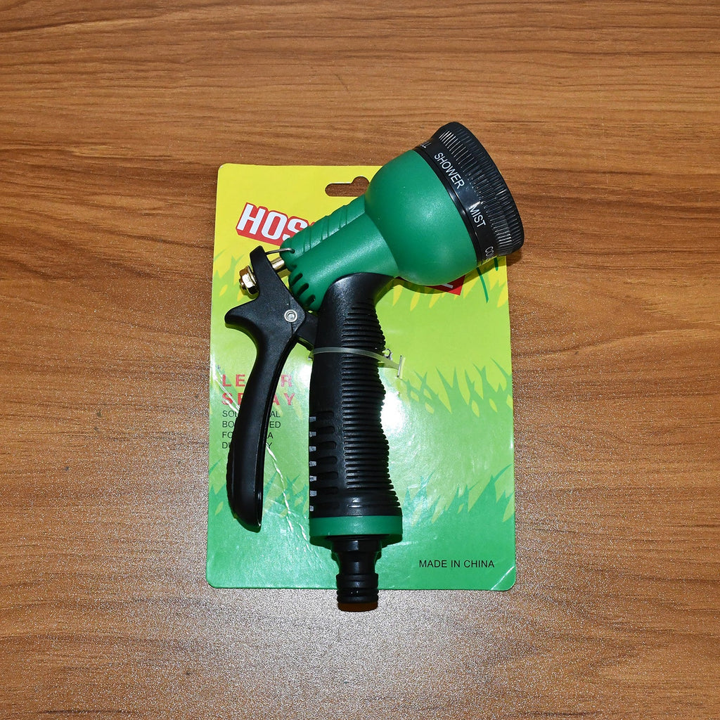 Multi-pattern garden hose spray nozzle in use watering outdoor plants