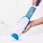 Effective double-sided pet fur remover brush shown removing hair from a fabric surface.
