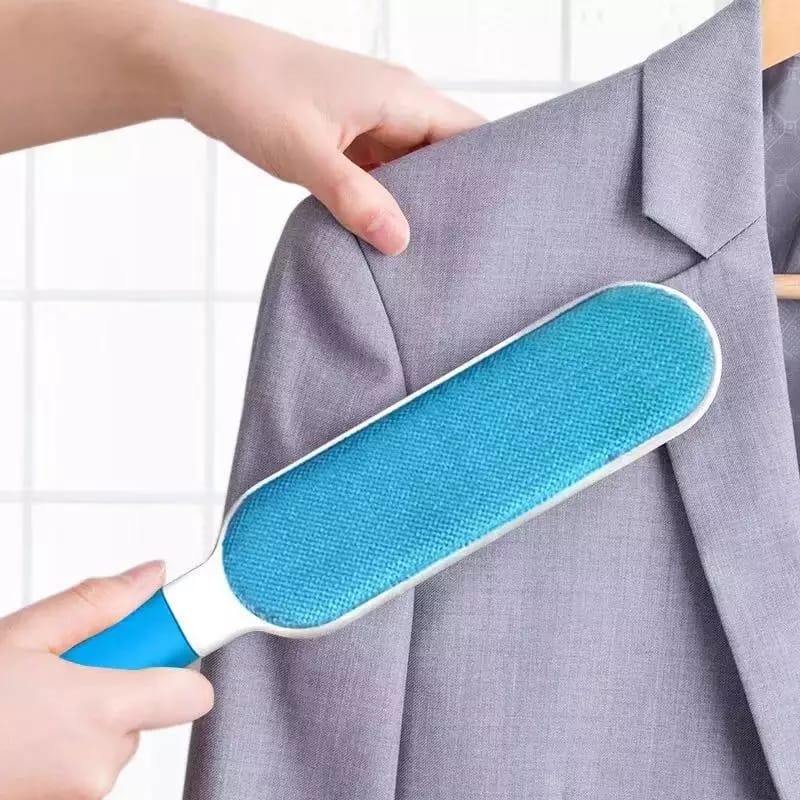 Close-up of the self-cleaning double-sided pet fur remover brush in action.