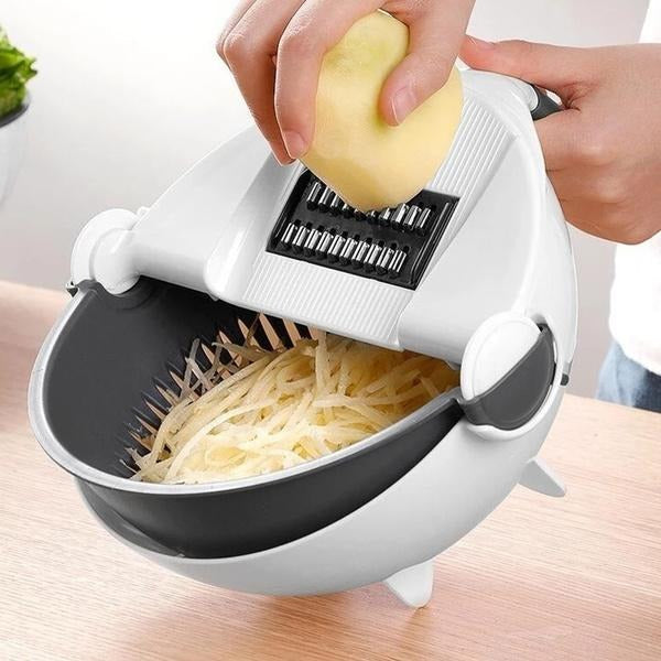 A hand using the 10-in-1 vegetable cutter slicer to prepare fresh vegetables with its rotating drain basket.