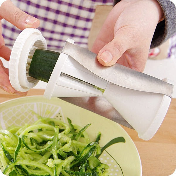 Easy-to-use kitchen slicer transforming carrots into spirals for a fresh salad.