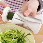 Easy-to-use kitchen slicer transforming carrots into spirals for a fresh salad.