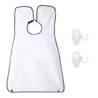 Man using a black beard apron with suction cups to catch hair clippings while shaving.