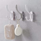 Close-up of a clear plastic self adhesive wall hook, ready for drill-free installation.