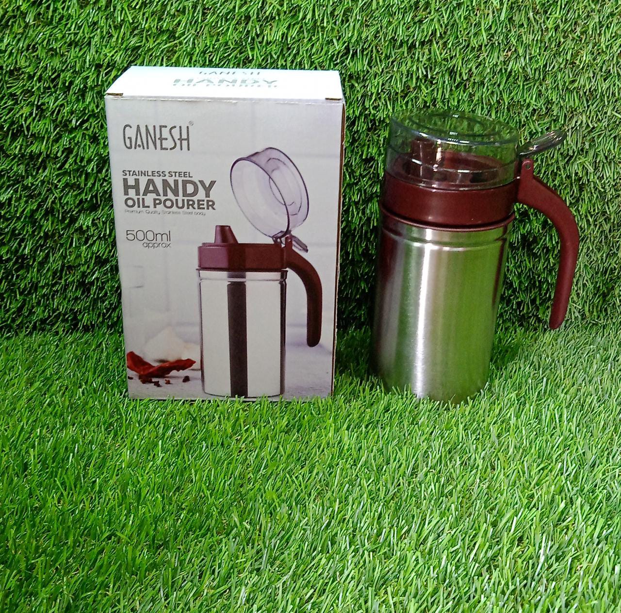 Lifestyle shot of the 500ml stainless steel oil dispenser in a modern kitchen setting.