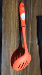 The robust nylon cooking shovel with a large scoop, ready for various culinary uses.