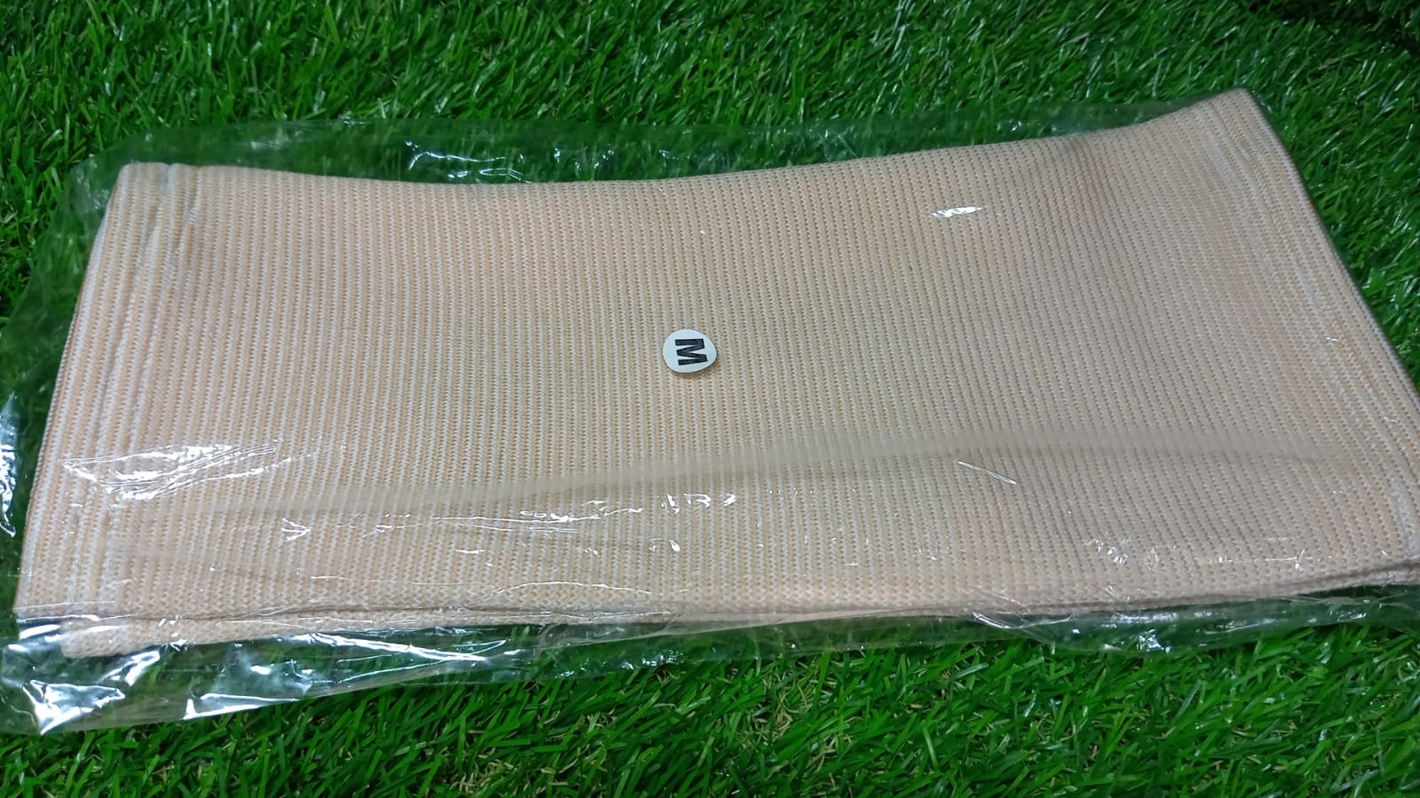 Person wearing a medium knee support cap under clothing for discreet support.