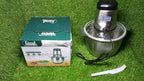 The stainless steel electric meat grinder placed on a modern kitchen counter, blending with decor.