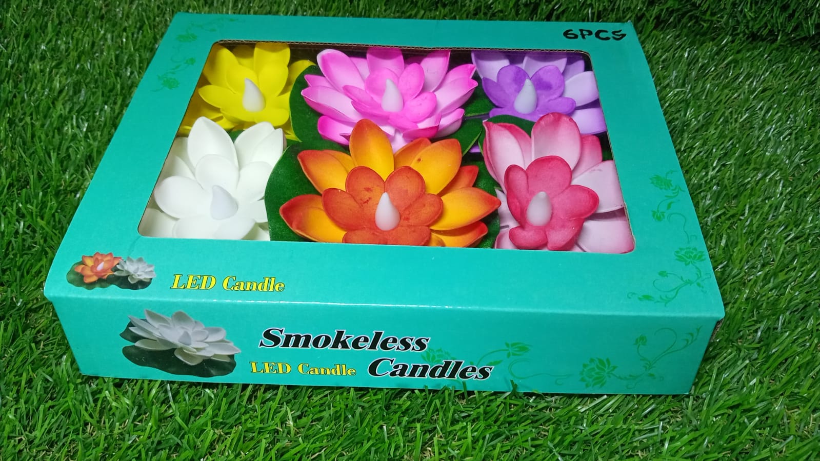 Overhead shot of a full pack of six Floating Lotus LED Candles in their retail packaging.