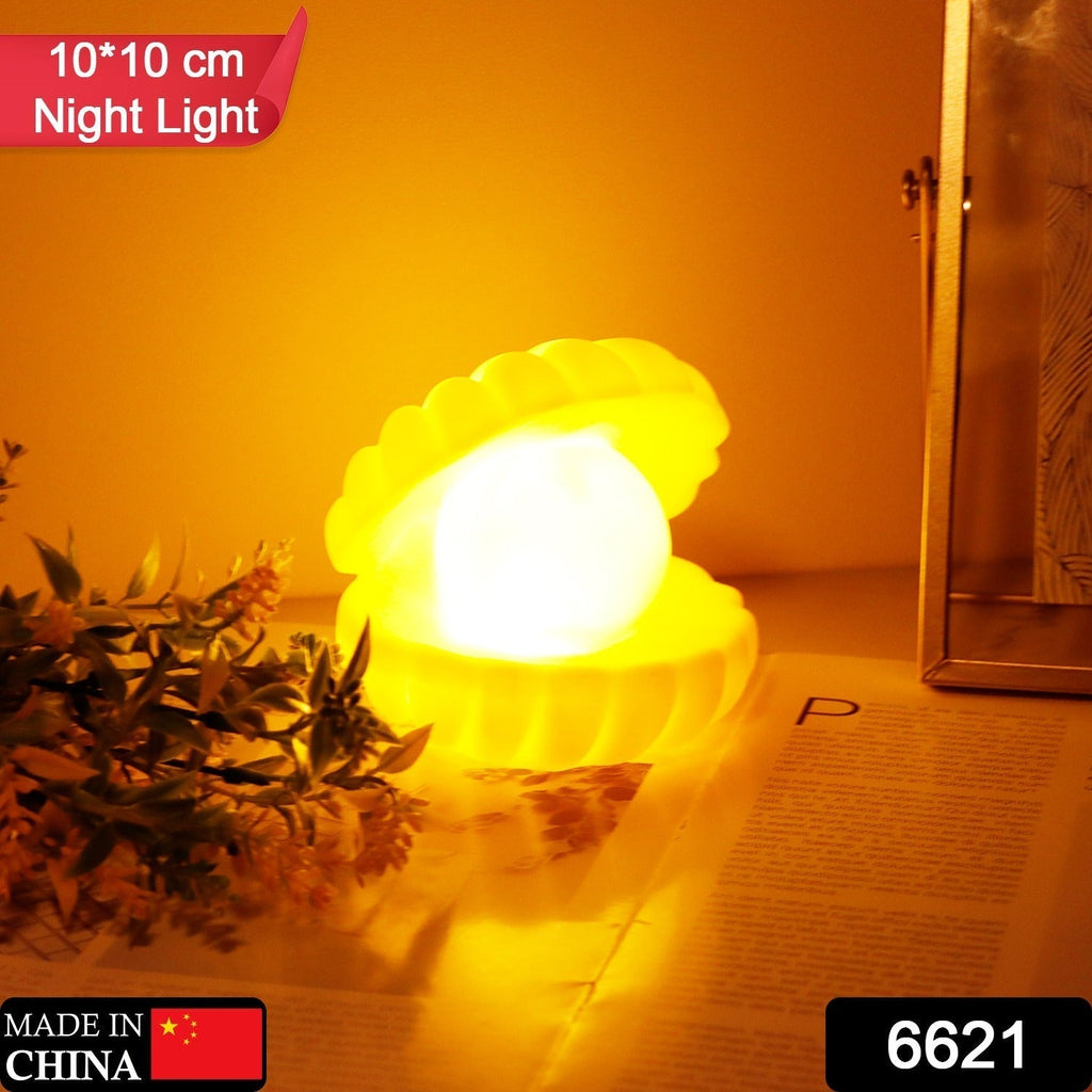 Close-up of the Pearl Shell Night Lamp illuminating a dark room.