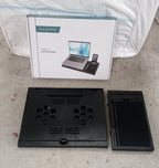 Lifestyle shot of the foldable laptop stand in use with a laptop.