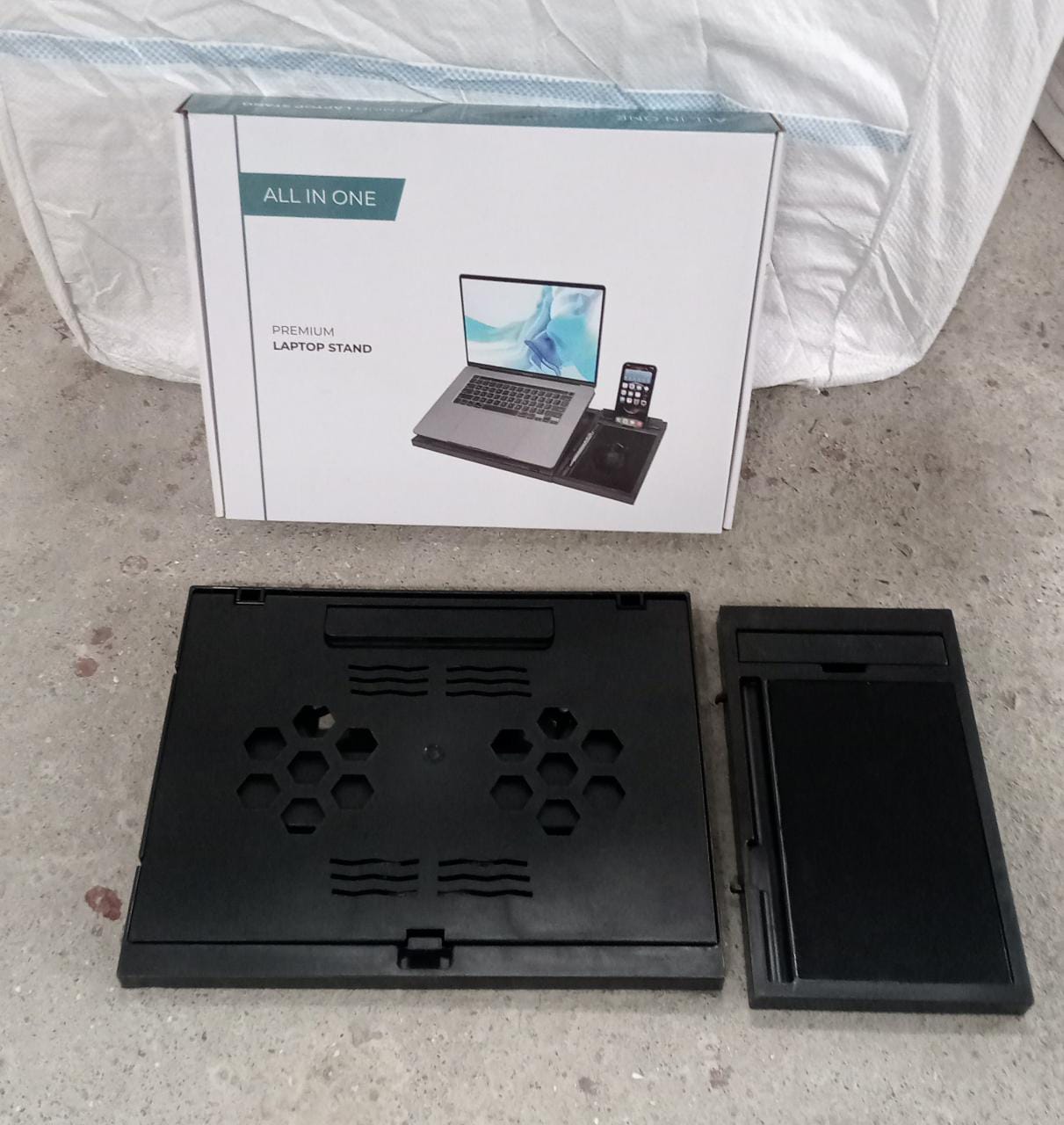 Lifestyle shot of the foldable laptop stand in use with a laptop.