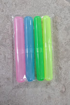 A hand holding a plastic toothbrush cover, demonstrating its portable size.