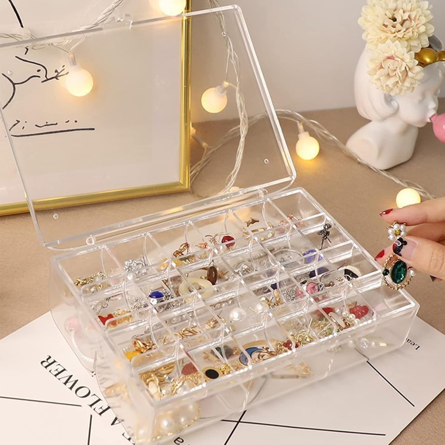 Top-down view of the open acrylic jewelry box revealing its spacious two-layer design.