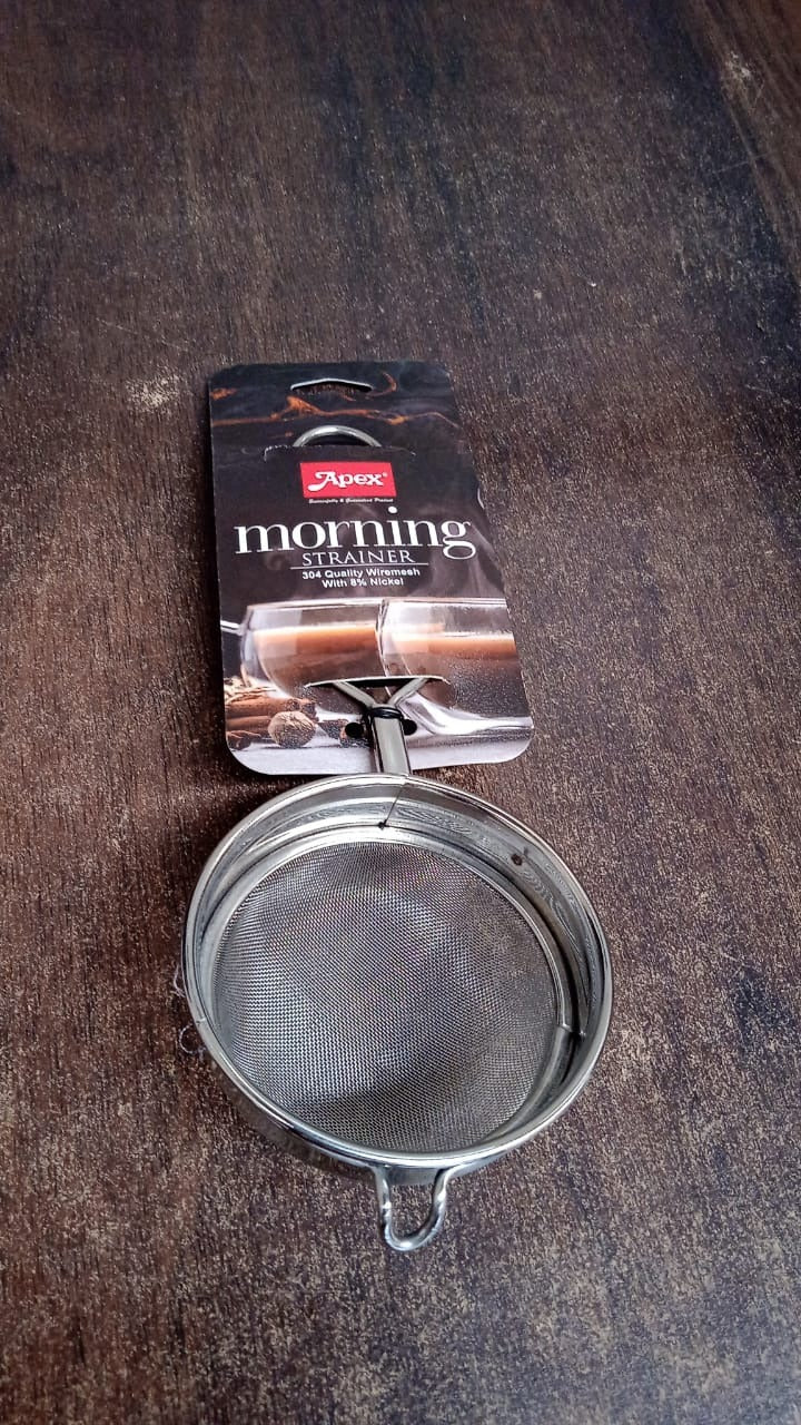 Stainless steel tea strainer positioned within a kitchen setting
