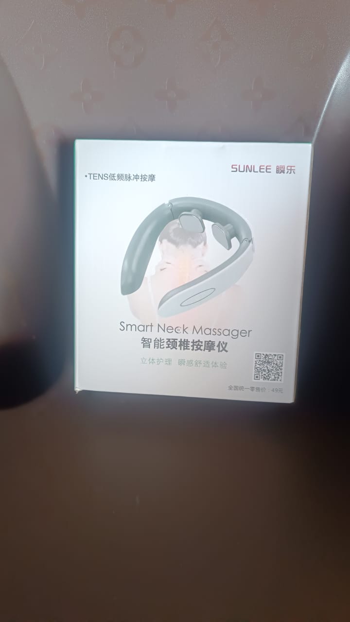 A lifestyle image showing the Electric Neck Massager in use for relaxation.