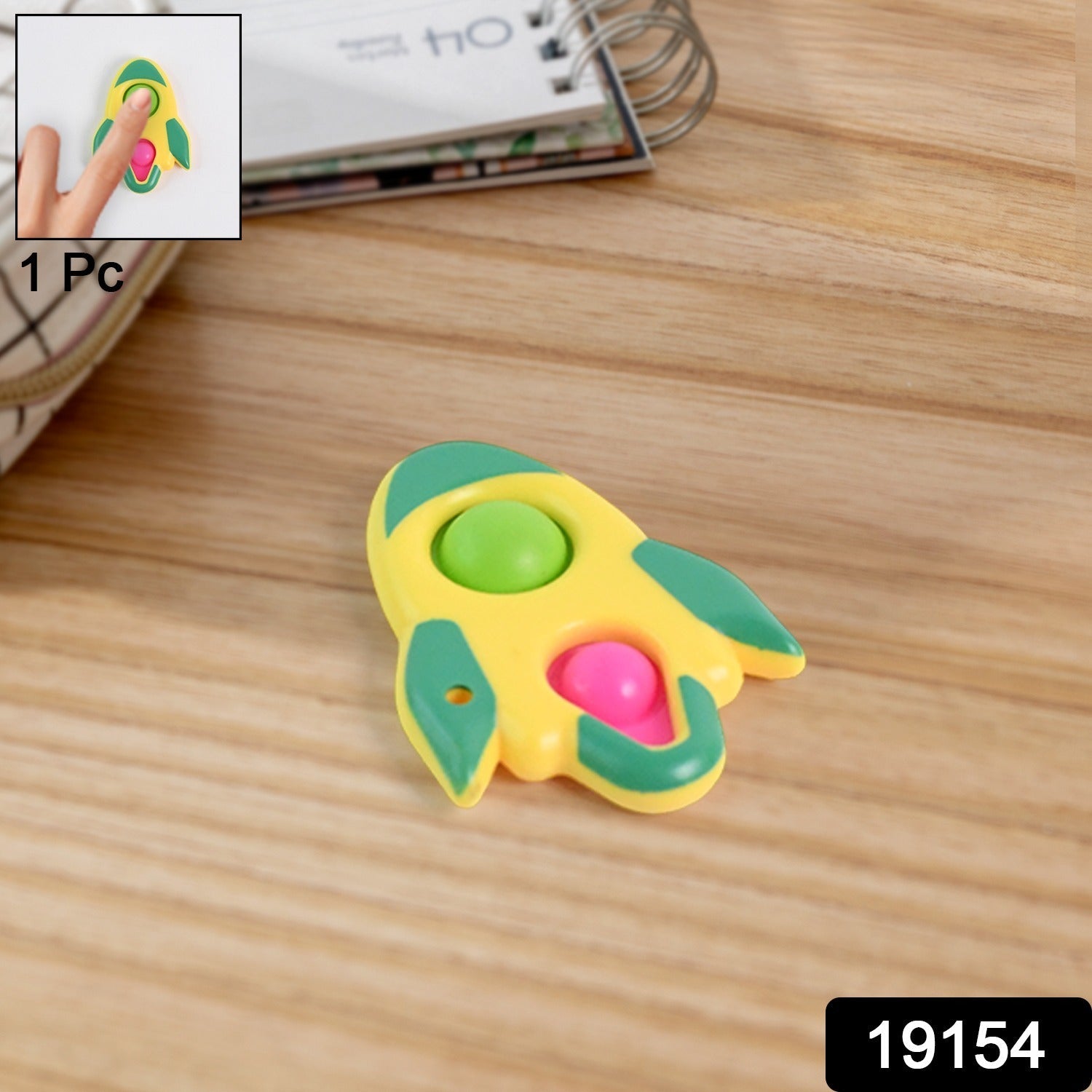 Hand holding the compact rocket fidget keychain toy showing its size
