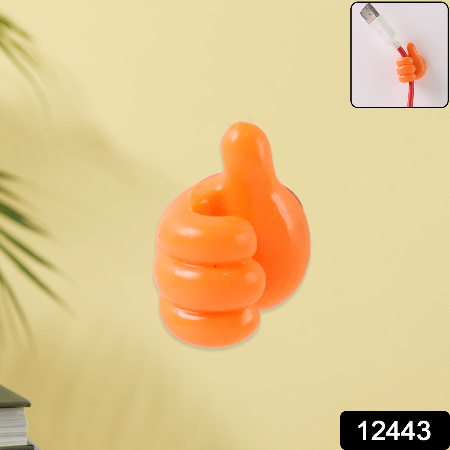 Bright orange palm snap silicone clip mounted on wall for keys