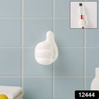 Close-up view of white palm-shaped multifunctional cable clip on wall