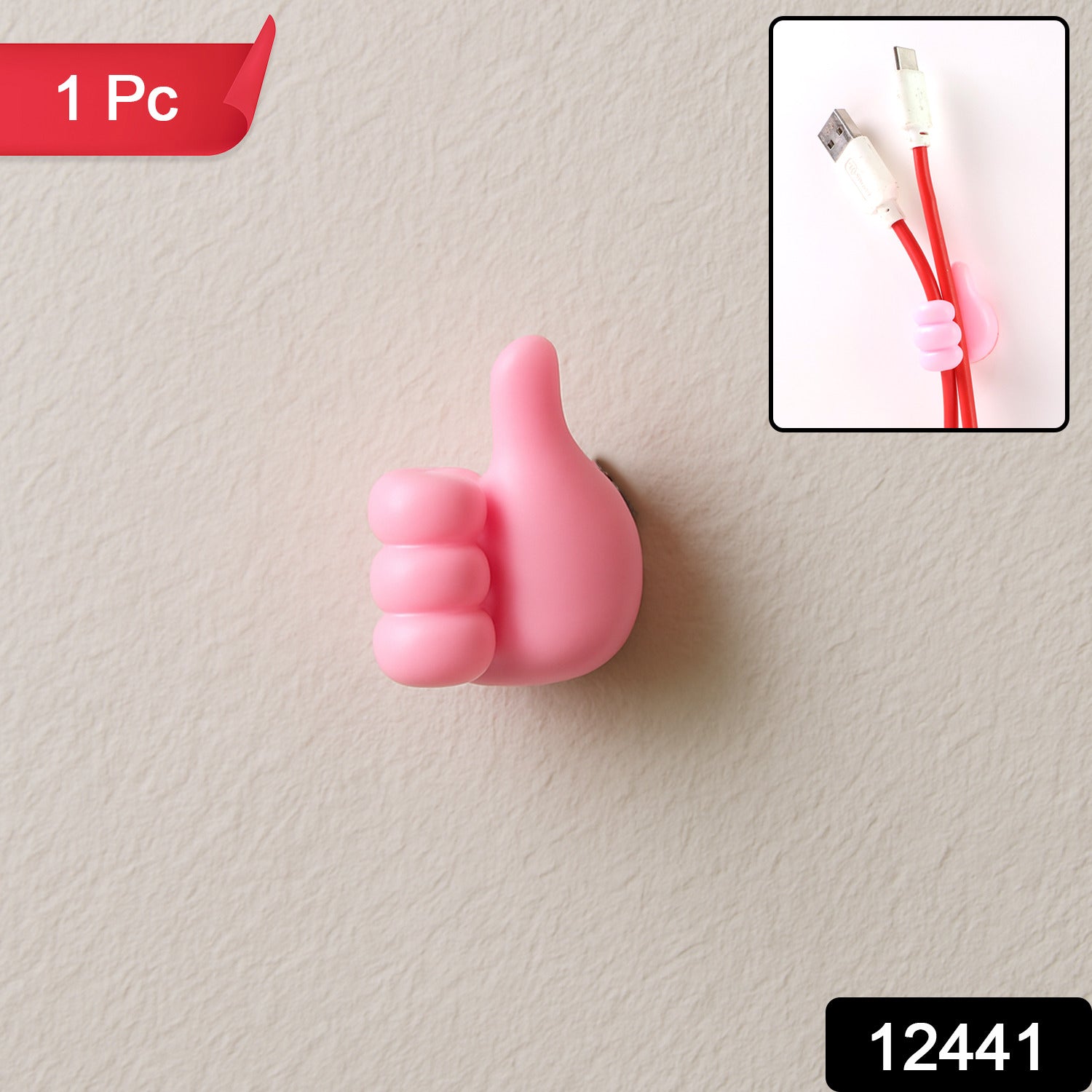 Pink thumb hook cable holder securely mounted on a wall surface