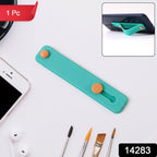 Close-up of teal green phone grip strap on mobile phone