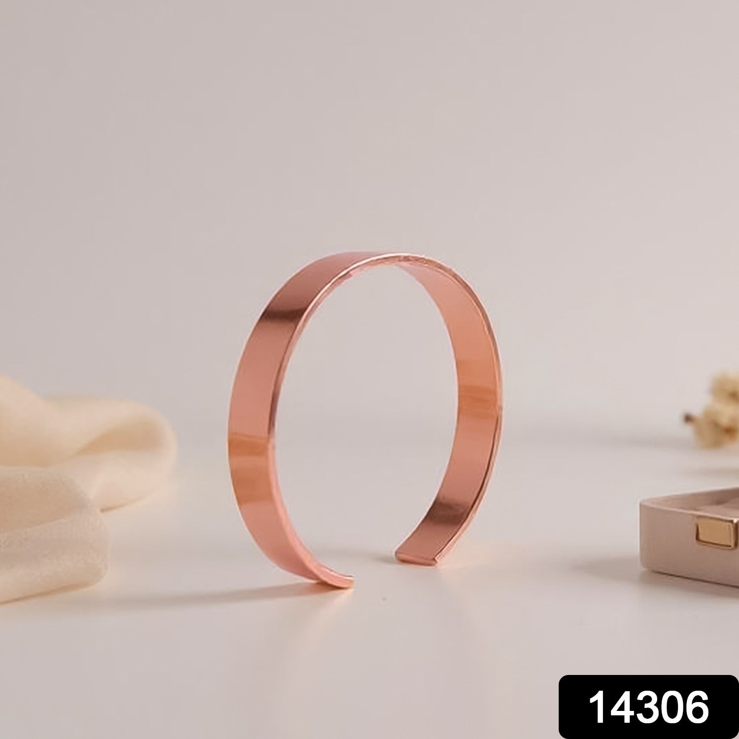 Rose gold kada bracelet displayed on a stand