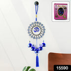 Protective Om Evil Eye wind chime hanging on wall with blue bells