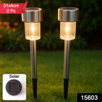Solar LED outdoor pathway bollard light illuminating a garden pathway