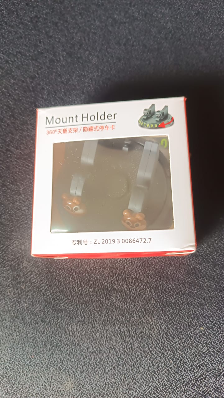 Dashboard mobile phone stand with hidden parking number plate display