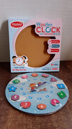 Wooden educational learning clock toy displayed on table with colorful blocks